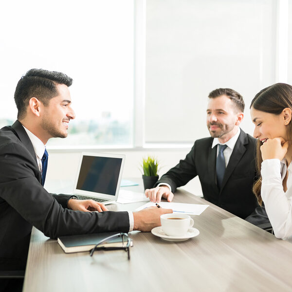 Smiling accountant discussing plan with colleagues in office